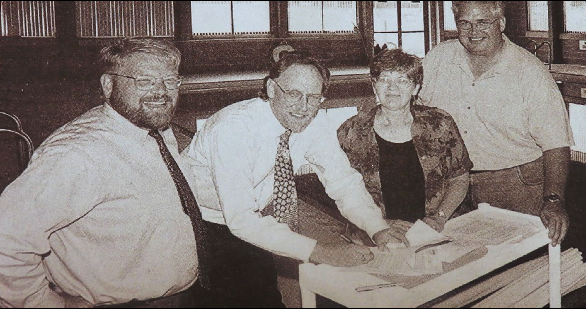 Ailene Fink prepares to sign lease with city officials