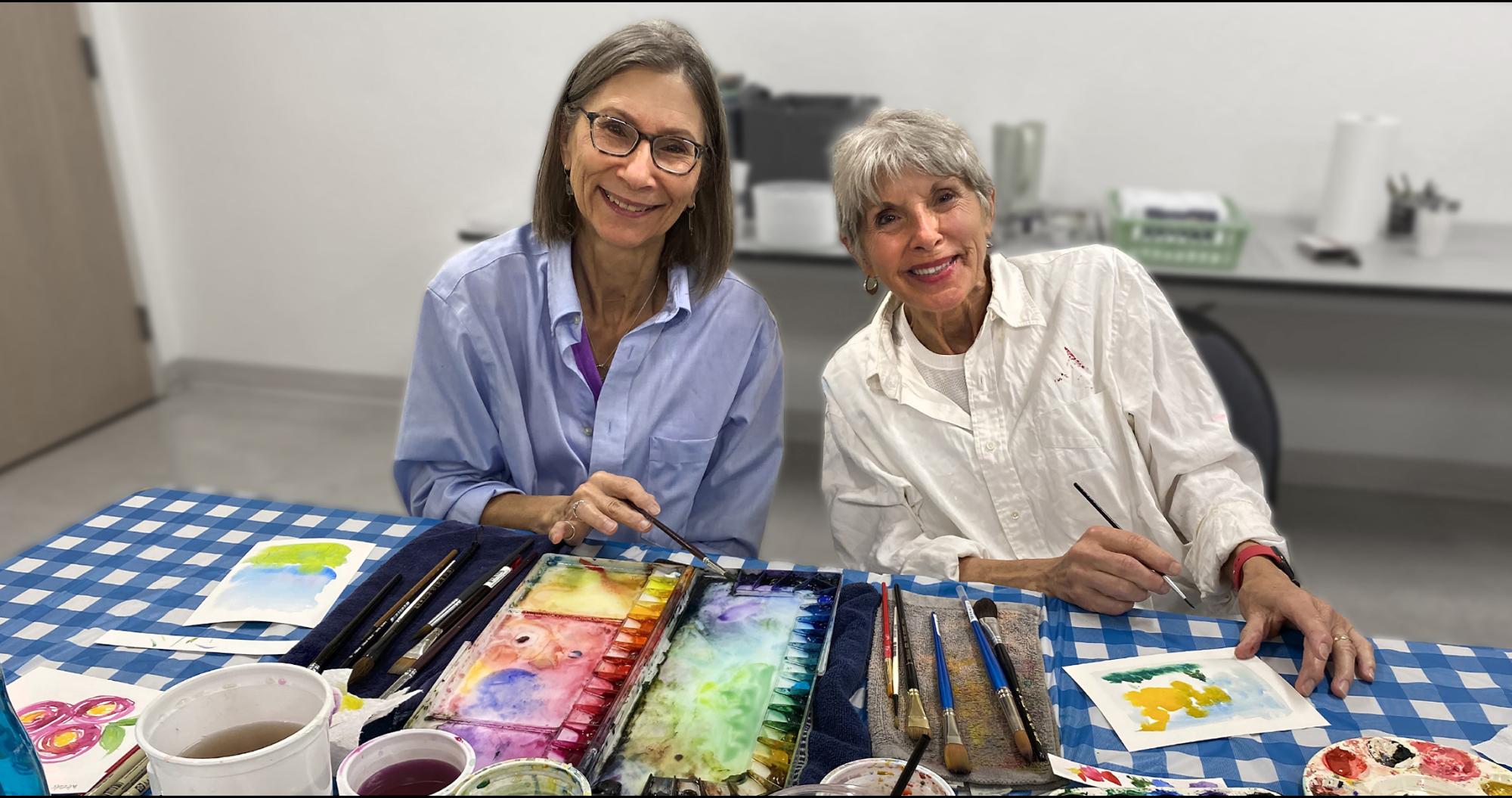 Two women doing wwatercolor painting