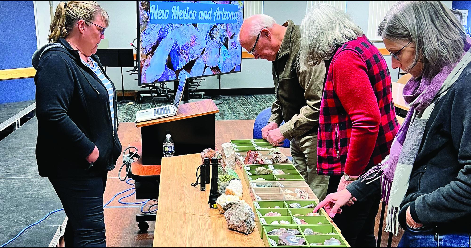 Members looking at display of rocks